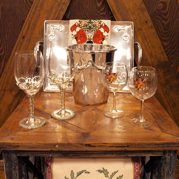 an arrangement of home decor items including glasses and a serving tray