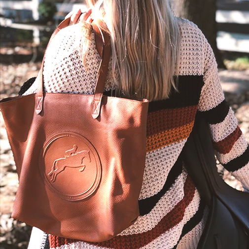 a lady with a tucker tweed handbag over her shoulder